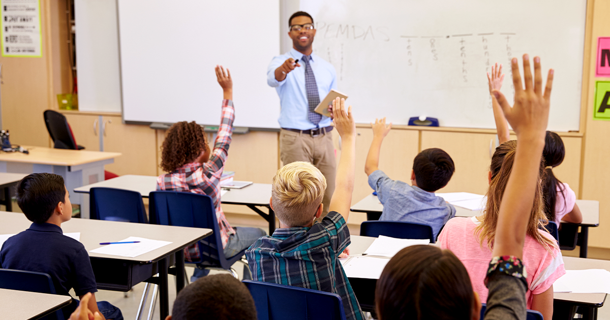 Teacher in classroom with young students