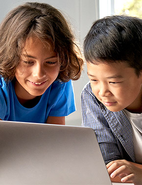 Two young students working together at a laptop